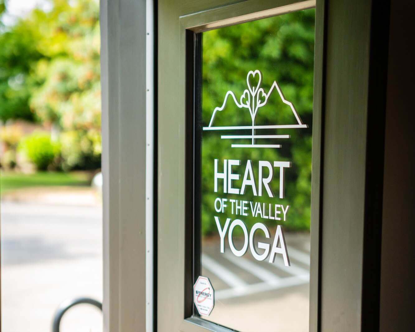 The studio front door, painted with the Heart of the Valley logo.