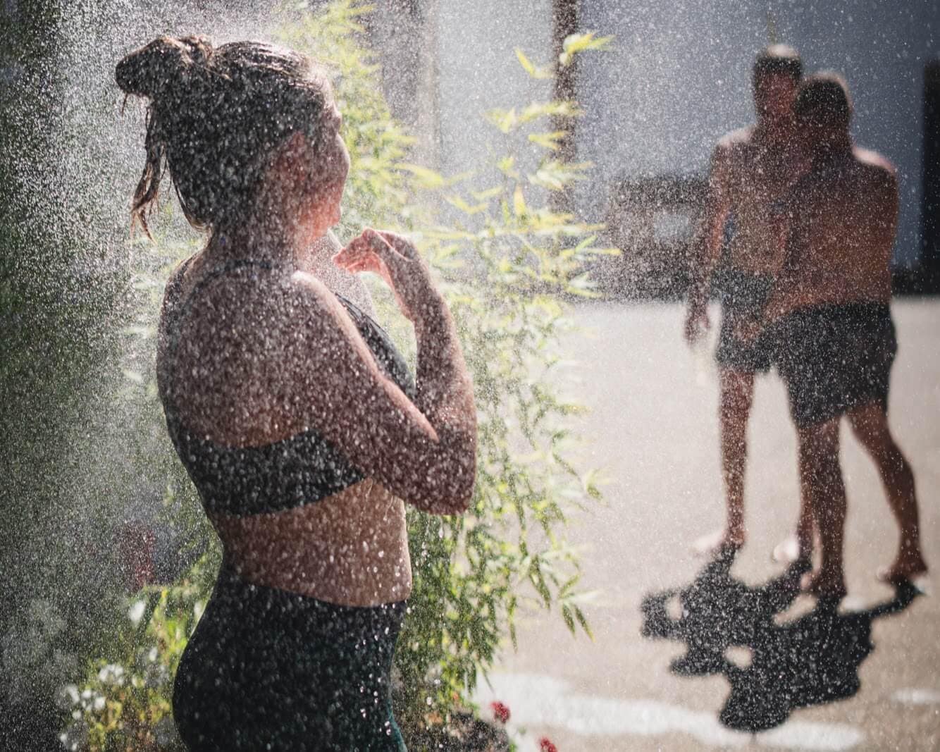 A member enjoying the outdoor shower.
