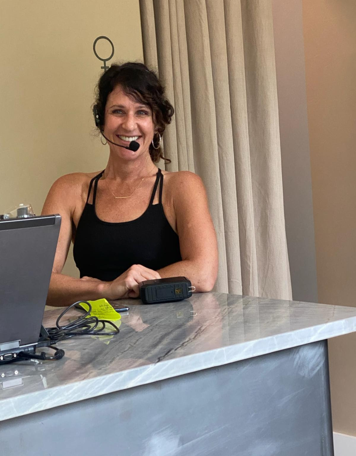 The Pilates instructor mid-demonstration in the studio.