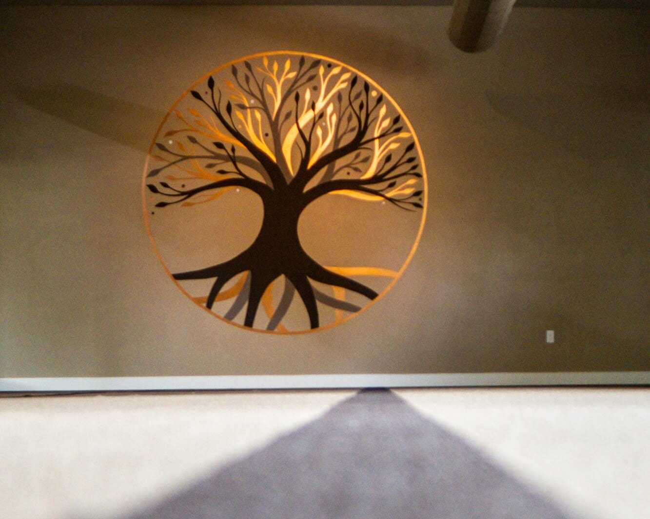 The copper tree-of-life mural in the practice room.